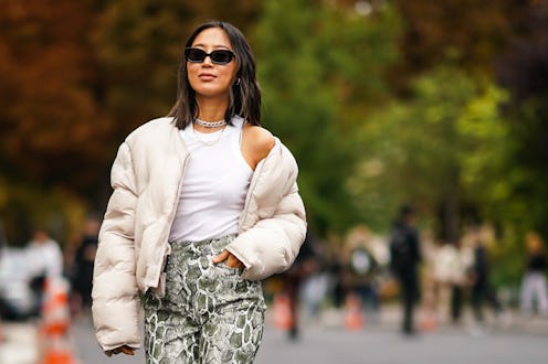 PARIS, FRANCE - SEPTEMBER 25: Aimee Song wears sunglasses, a white puffer jacket, a white sleeveless...