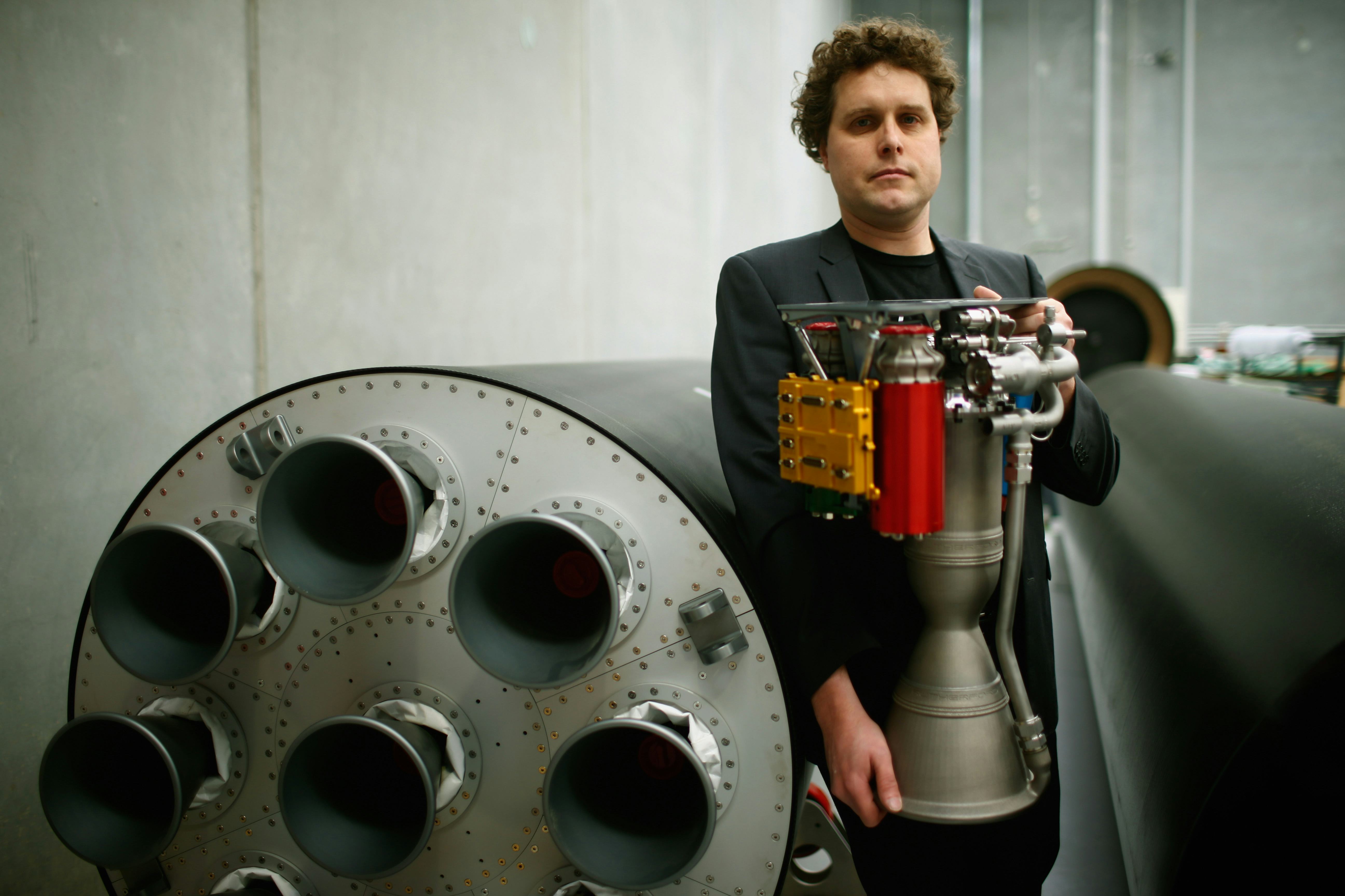 AUCKLAND, NEW ZEALAND - JUNE 10: RocketLab CEO, Peter Beck poses with The Rutherford at the company's Auckland headquarters on June 10, 2015 in Auckland, New Zealand. The Rutherford, a battery-powered rocket engine printed on 3D parts developed by New Zealand space technology company, RocketLab, is set to reduce the cost for companies to send satellites to space by as much as US$5-45 million. Test flights will begin this year with a goal to provide commercial launch operations by 2016. (Photo by Phil Walter/Getty Images)