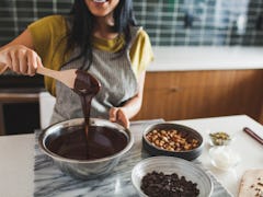 A woman makes a TikTok Recipe Using Reese's Peanut Butter Cups in her kitchen.