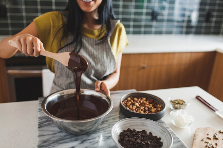 A woman makes a TikTok Recipe Using Reese's Peanut Butter Cups in her kitchen.