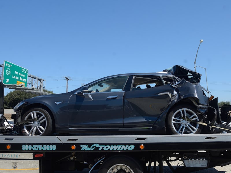 SEAL BEACH, CA - AUGUST 15: A damaged Tesla sits on a tow truck after a collision in the HOV lane on...