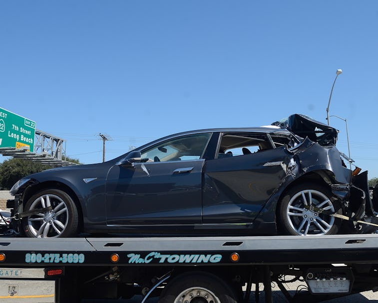 SEAL BEACH, CA - AUGUST 15: A damaged Tesla sits on a tow truck after a collision in the HOV lane on...