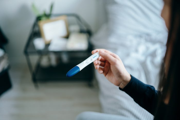 woman looking at pregnancy test