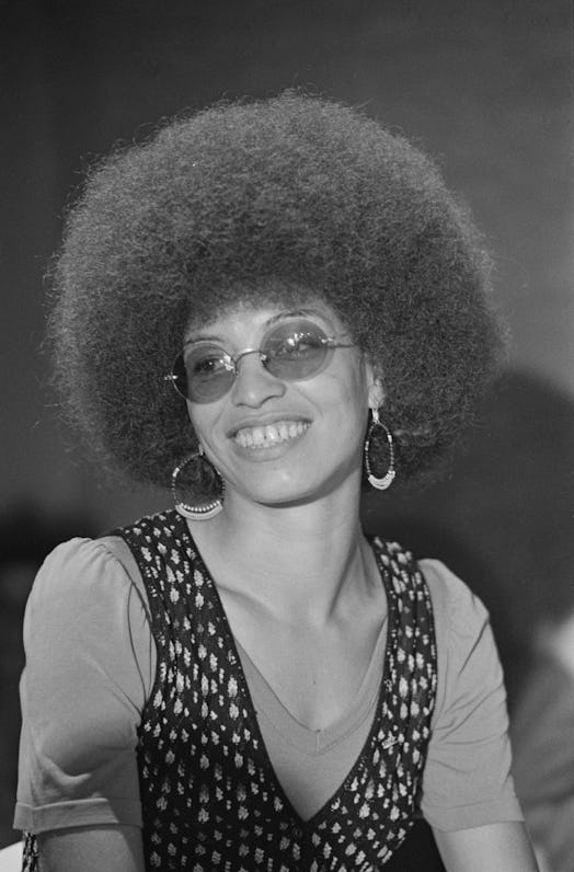 Angela Davis with a signature curly hairstyle smiling