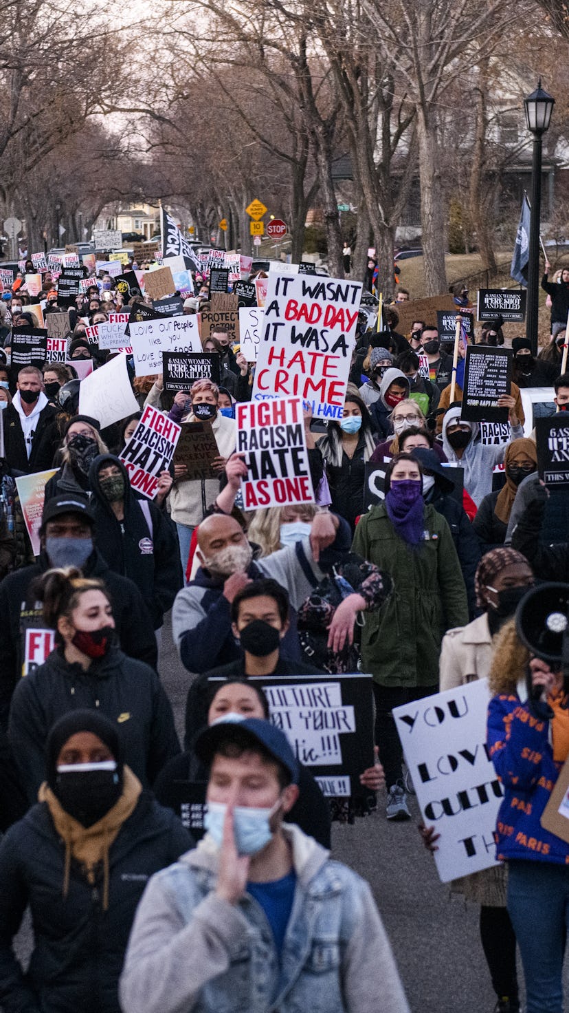 MINNEAPOLIS, MN - MARCH 18: People march through a neighborhood to protest against anti-Asian violen...