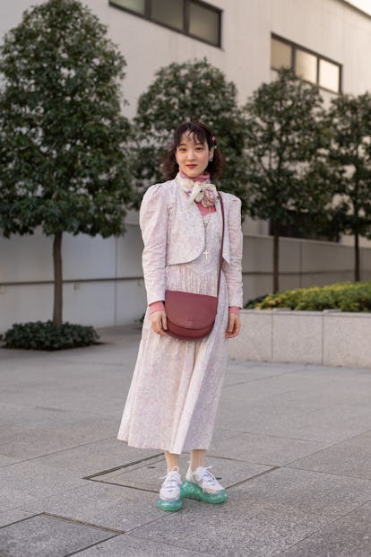 TOKYO, JAPAN - MARCH 15: A guest is seen on the street wearing pink floral print 2 piece vintage out...