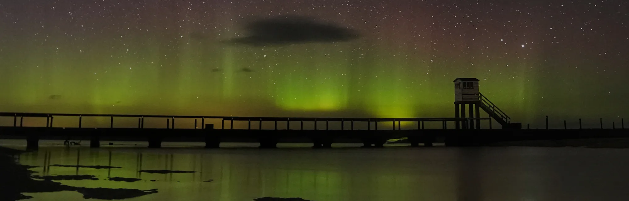 The Northern Lights and the Milky Way above the refuge hut where Holy Island in Northumberland is linked to the mainland by a long causeway where twice each day the incoming tide covers the road. Safe crossing times are displayed for motorists but when drivers get caught out they can take refuge in the hut and be rescued or wait for the next low tide. Picture date: Monday March 15, 2021. (Photo by Owen Humphreys/PA Images via Getty Images)