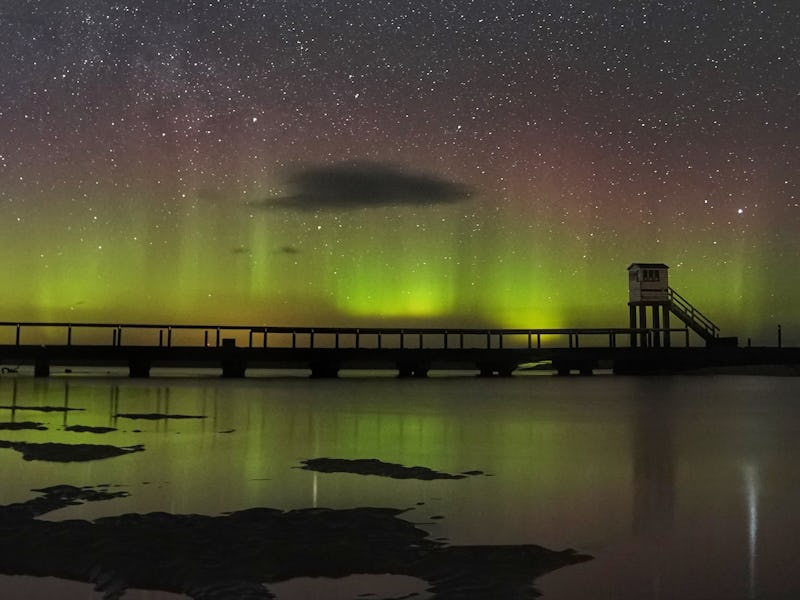 The Northern Lights and the Milky Way above the refuge hut where Holy Island in Northumberland is li...