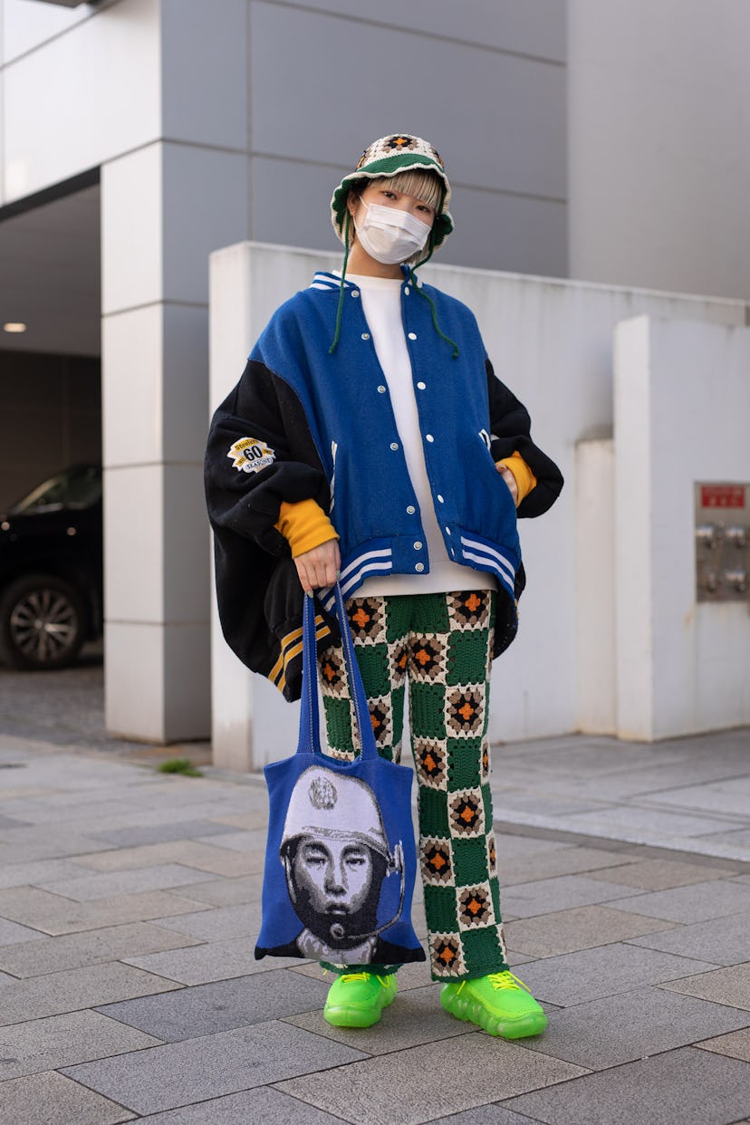 TOKYO, JAPAN - MARCH 15: A guest is seen on the street wearing colorful design knit bucket hat and p...