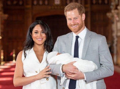 TOPSHOT - Britain's Prince Harry, Duke of Sussex (R), and his wife Meghan, Duchess of Sussex, pose f...