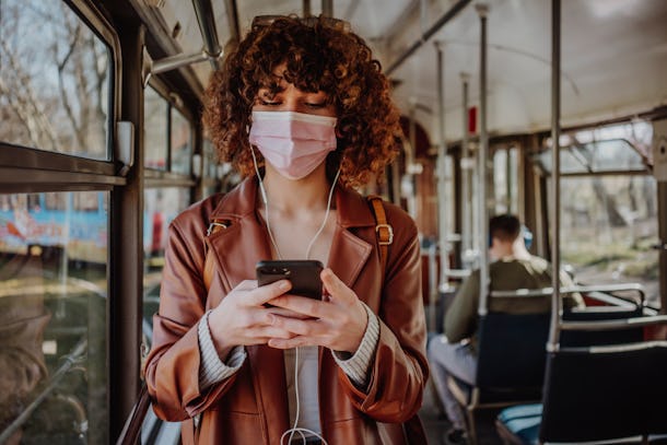 Young woman in public transportation during the pandemic