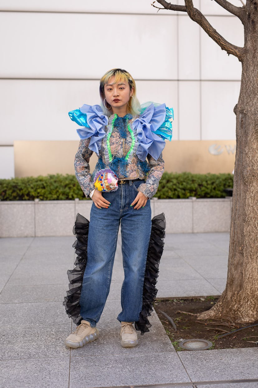 TOKYO, JAPAN - MARCH 15: A guest is seen on the street wearing floral print shirt with turquoise and...