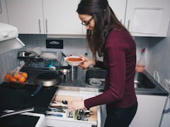 A woman in her kitchen recreates this tomato soup recipe on TikTok.