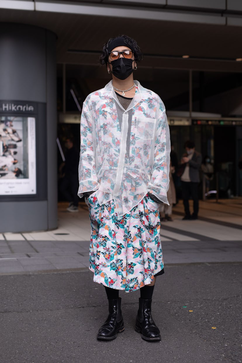 TOKYO, JAPAN - MARCH 20: A guest is seen on the street wearing a shear shirt, floral print robe, bla...
