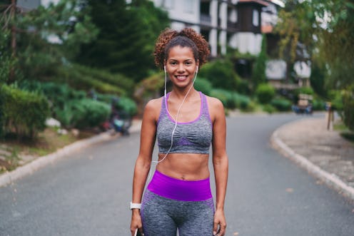 Mixed race woman sports training, smiling to the camera