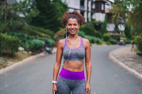 Mixed race woman sports training, smiling to the camera