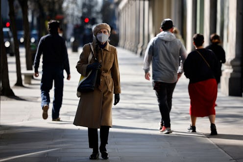 A pedestrian wearing a face covering walks along a quiet Oxford Street in central London on March 22...