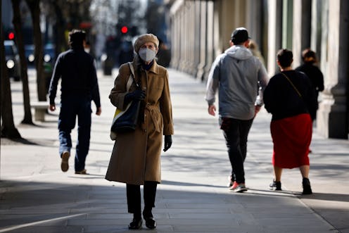 A pedestrian wearing a face covering walks along a quiet Oxford Street in central London on March 22...