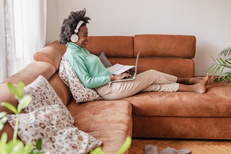 A woman is at home, she is using a laptop and while attending online therapy she found through the b...