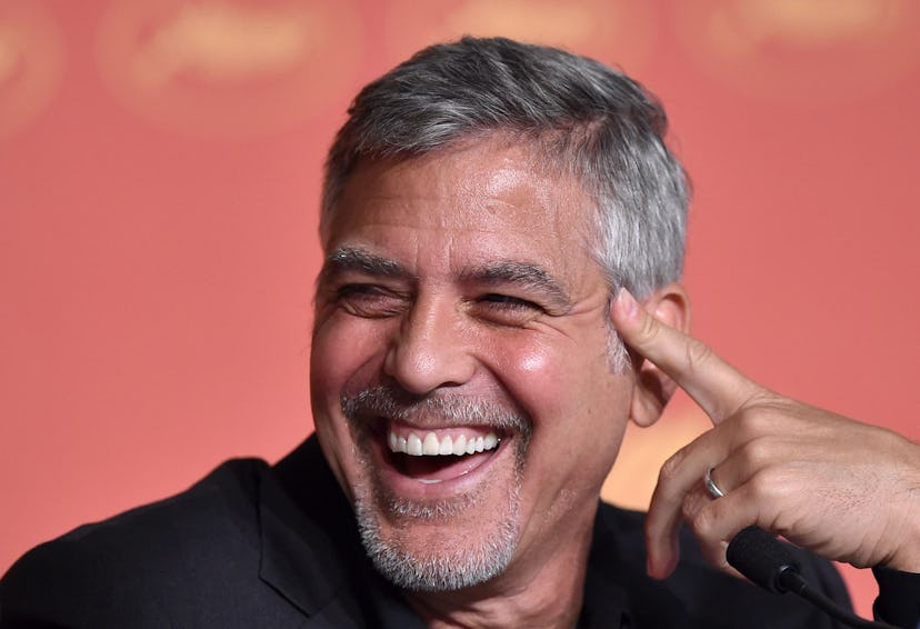 US actor George Clooney laughs on May 12, 2016 during a press conference for the film "Money Monster...
