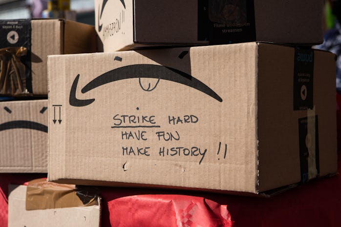 An Amazon box with the smile logo turned upside down is seen at a protest.