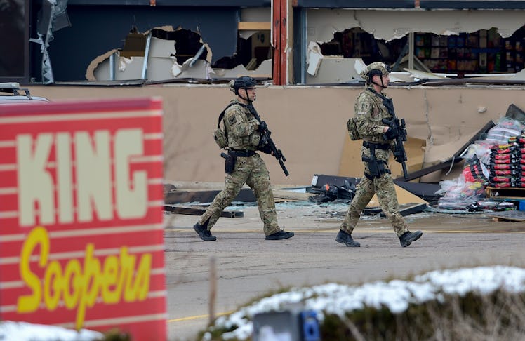 BOULDER, CO - March 22:Armed police officers are seen outside broken windows at King Soopers on Tabl...