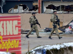 BOULDER, CO - March 22:Armed police officers are seen outside broken windows at King Soopers on Tabl...