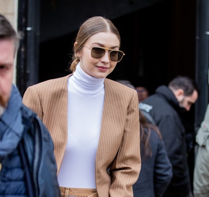 PARIS, FRANCE - FEBRUARY 27: Gigi Hadid is seen wearing camel blazer and asymmetric pants outside Ch...