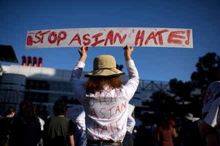 TOPSHOT - Sally Sha holds up a sign during a Stop Asian Hate rally at Discovery Green in downtown Ho...