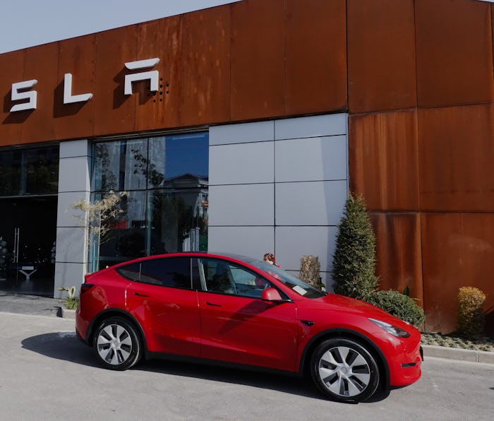 SHANGHAI, CHINA - JANUARY 18: A customer stands by her new China-made Model Y compact crossover vehi...