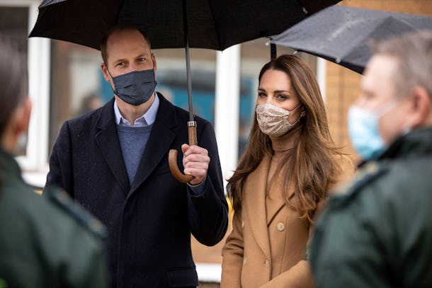 Britain's Prince William, Duke of Cambridge (L) and Britain's Catherine, Duchess of Cambridge, both wearing face coverings due to Covid-19, talk with members of the ambulance service in the wellbeing garden during a visit to Newham Ambulance Station in east London on March 18, 2021, where they learned about their experiences during the coronavirus pandemic. (Photo by RICHARD POHLE / POOL / AFP) (Photo by RICHARD POHLE/POOL/AFP via Getty Images)