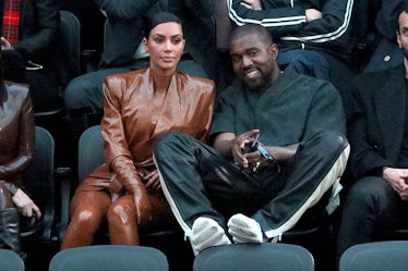Kim Kardashian in a brown leather outfit and Kanye West in a black top and trousers