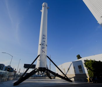 The recovered first stage of a Falcon 9 rocket stands at Space Exploration Technologies Corp. (Space...
