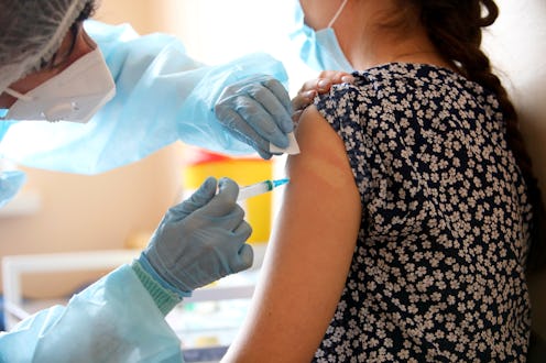 A woman receives a dose of the COVID vaccine. Post-COVID, some long haulers are experiencing relief ...