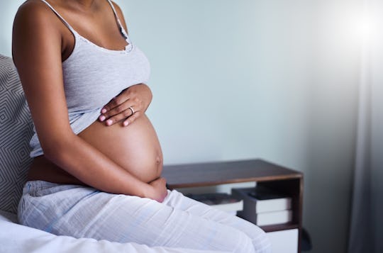 Shot of an expectant woman at home