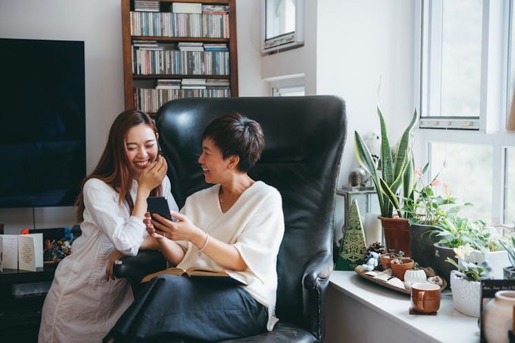 A mother and daughter are having fun and laughing over a funny Mother's Day card on Etsy.