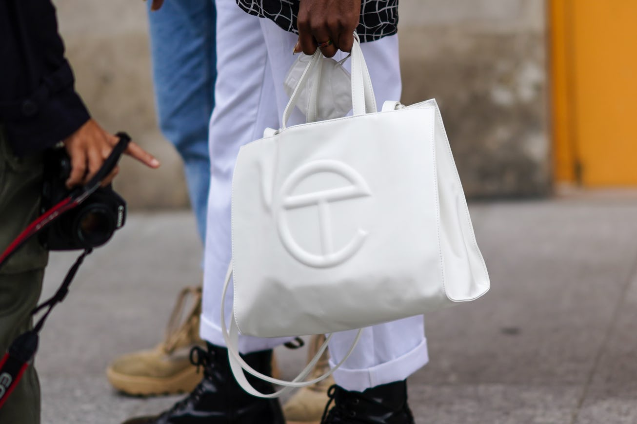 PARIS, FRANCE - OCTOBER 06: A guest wears a white Telfar leather bag, outside Louis Vuitton, during ...