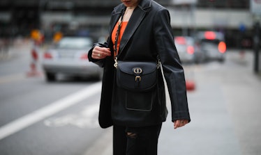 HAMBURG, GERMANY - MARCH 17: Tugba Kement wearing black NA-KD leather blazer, orange Zara top, black...