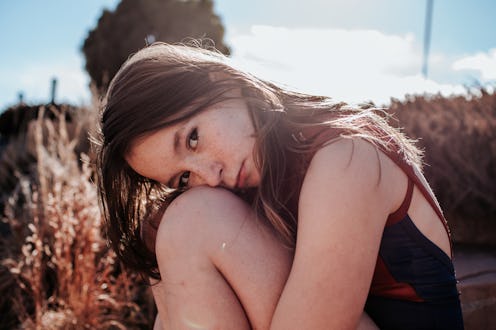 teenager sitting outside