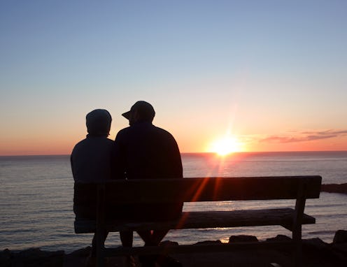 couple watching the sunset on a bench