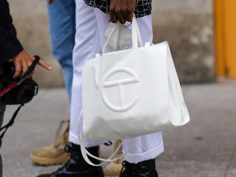 PARIS, FRANCE - OCTOBER 06: A guest wears a white Telfar leather bag, outside Louis Vuitton, during ...