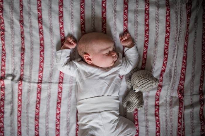 baby sleeping with arms overhead