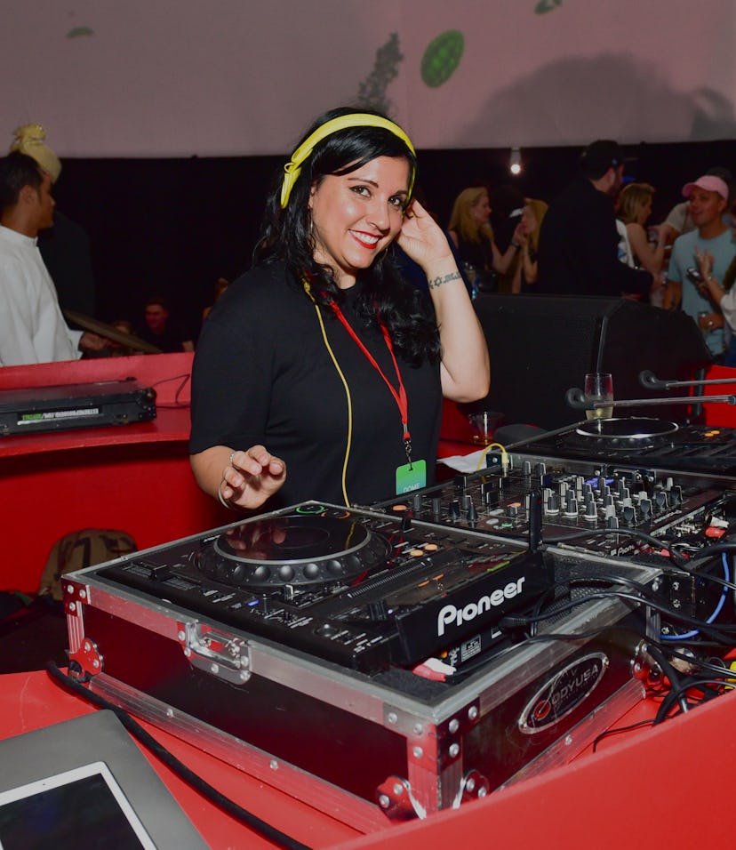 A DJ is seen playing on a set.