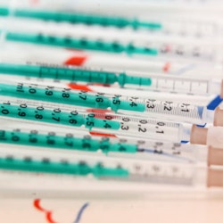 Covid-19 vaccines on a tray. Women describe what it's like to be eligible for the covid vaccine base...