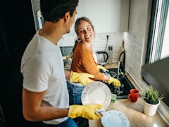 A couple cleaning at home after looking up spring cleaning hacks on TikTok.