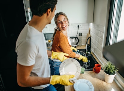 A couple cleaning at home after looking up spring cleaning hacks on TikTok.