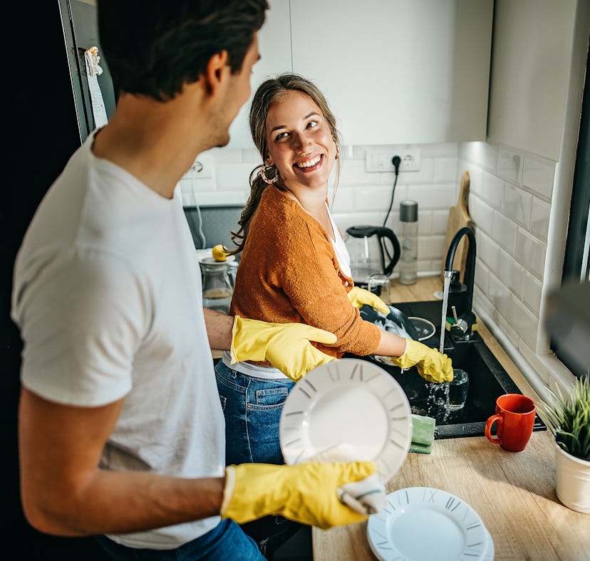 A couple cleaning at home after looking up spring cleaning hacks on TikTok.