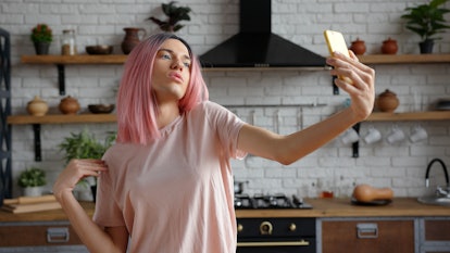 A fabulously pink woman snaps a glam selfie while showing off a new hair trend.