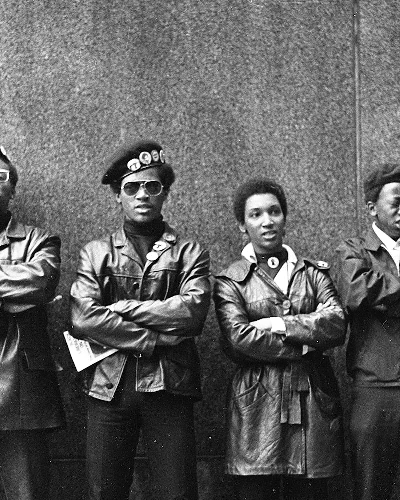 View of several Black Panther Party members as they demonstrate, arms folded, outside the New York C...