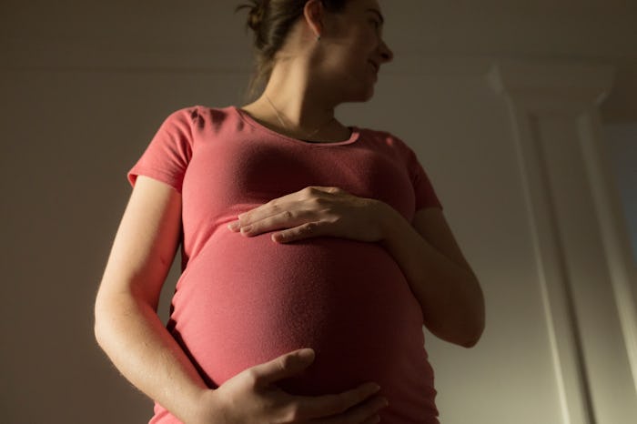 pregnant woman holding belly